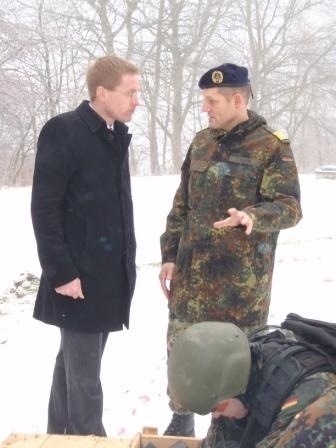 Fregattenkapitän Stefan Platz erläutert Daniel Günther die Arbeitsweise des SEK M